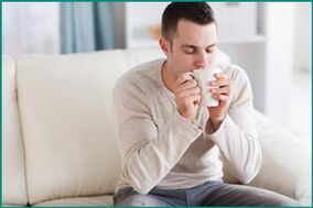 A man drinks tea with mint to cure erectile dysfunction. 